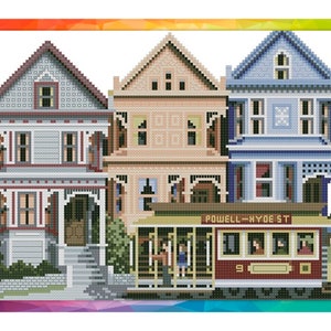 May include: A colourful illustration of three Victorian-style houses in San Francisco, California. A red cable car with the text "POWELL-HYDE ST" is in front of the houses.