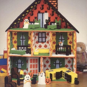 May include: A Halloween-themed dollhouse with a green roof and orange and black walls. The dollhouse is decorated with pumpkins, ghosts, and cats. It has a kitchen, bedroom, and living room.