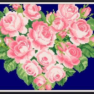 May include: A heart-shaped arrangement of pink roses with green leaves on a dark blue background.