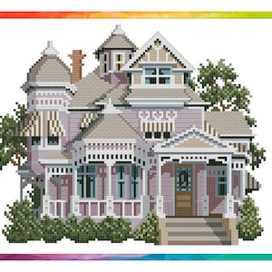 May include: A cross-stitch pattern of a large, detailed, light pink Victorian house with white trim and a wraparound porch. The house has a steep roof, multiple gables, and a turret. There are green bushes and trees surrounding the house.