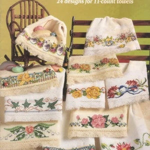May include: A book titled "Big Stitch Towels" with 24 designs for 11-count towels. The cover features a variety of towels with cross-stitch embroidery designs, including floral patterns, butterflies, and ivy.