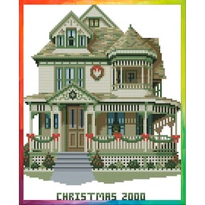 May include: A green and white Victorian-style house with a porch decorated for Christmas. The house has a red wreath on the front door and red bows on the porch railings. The text "CHRISTMAS 2000" is at the bottom of the image.