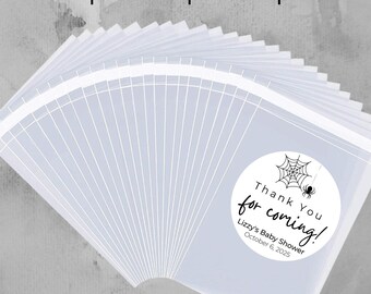 May include: A set of clear plastic bags with black and white labels that say "Thank You for coming!" with a spider web and spider design. The labels also include the text "Lizzy's Baby Shower" and "October 6, 2025". The bags are available in various sizes: 2x3, 3x4, 5x7, and 6x9 inches.
