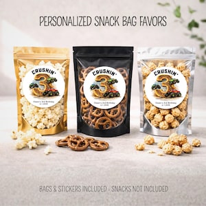 May include: Three snack bags filled with popcorn and pretzels, each with a circular sticker that reads "Crushin'" and "Owen's 3rd Birthday 6.1.2028". The bags are gold, black, and clear. Text at the top says "PERSONALIZED SNACK BAG FAVORS".