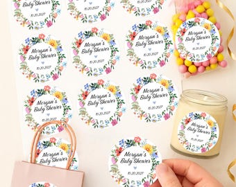 May include: Custom stickers for baby showers. The stickers feature a floral wreath design with the text "Morgan's Baby Shower" and the date "10.20.2027". The stickers are available in various sizes, ranging from 1 inch to 3.33 inches.