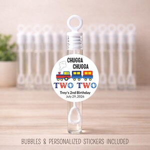 May include: Clear bubble wand with a white top and a round label. The label features a train graphic with the text "CHUGGA CHUGGA" and "TWO TWO". The text "Trey's 2nd Birthday July 29, 2026" is also included.