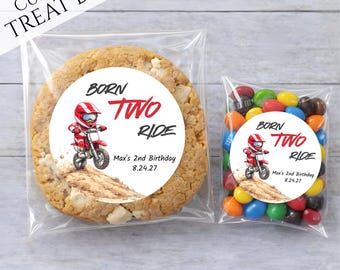 May include: Clear cellophane treat bags, one with a large cookie and the other with colorful candies. Each bag has a circular sticker with a cartoon motorcycle rider and the text "BORN TWO RIDE" and "Max's 2nd Birthday 8.24.27".