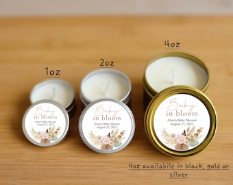 May include: Three sizes of candles in silver and gold tins with a floral design and the text "Baby in bloom" with the event details "Alice's Baby Shower August 23, 2023". The candle sizes are 1 oz, 2 oz, and 4 oz. The 4 oz candles are available in black, gold, or silver.