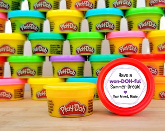 May include: A red container with a white sticker that says "Have a won-DOH-ful Summer Break! Your Friend, Macie" with a purple heart. The container is surrounded by small yellow, green, blue, and red containers of Play-Doh.