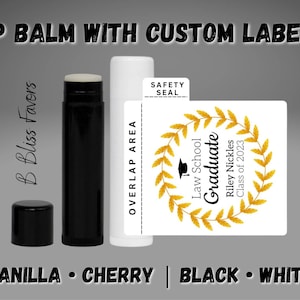 May include: A white lip balm tube with a black cap and a custom label. The label has a gold wreath with the text "Law School Graduate Riley Nickles Class of 2023". The label also has the text "Safety Seal" on the top.