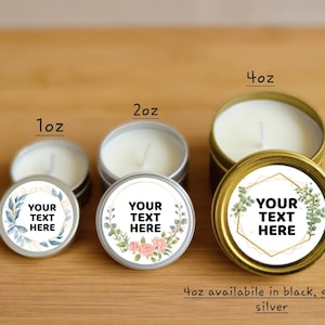 May include: Three sizes of candle tins with floral labels. The labels have gold accents and the text "Your Text Here". The tins are available in 1 ounce, 2 ounce, and 4 ounce sizes. The 4 ounce tin is available in black, gold, or silver.