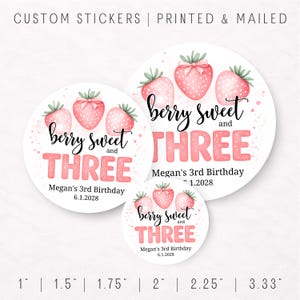 May include: Round stickers with a strawberry theme. The stickers say "berry sweet and THREE" in pink and black lettering. The stickers are for Megan's 3rd birthday, with the date 6.1.2028. Sizes range from 1 inch to 3.33 inches.