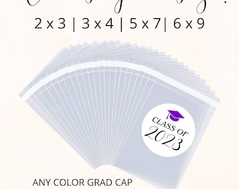 May include: A stack of clear plastic bags with labels that say "Class of 2023" with a purple graduation cap. The text "Choose your size! 2x3 | 3x4 | 5x7 | 6x9" is at the top of the image. The text "ANY COLOR GRAD CAP Comes with bags & labels!" is at the bottom of the image.