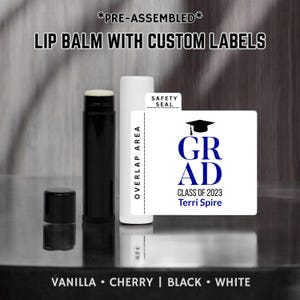 May include: A black lip balm tube with a white label that says "GRAD" in blue letters with a graduation cap above the text. The label also says "Class of 2023" and "Terri Spire".