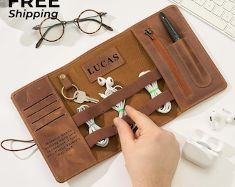 May include: A brown leather tech organizer with the name "LUCAS" embossed on it. The organizer holds keys, earbuds, and charging cables. The text "Distance means nothing when love is constant. I love you. Happy Father's Day, Dad!" is printed on the side.