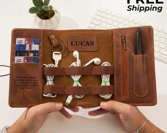 May include: A brown leather organizer with multiple compartments, holding cards, keys, and cables. The organizer has the name "LUCAS" embossed on it. Text on the organizer reads "Distance means nothing when love is constant. I love you. Happy Father's Day, Dad!"
