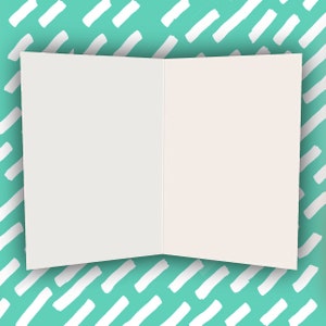 May include: A blank white card with a folded edge, sitting on a turquoise background with a white diagonal stripe pattern.