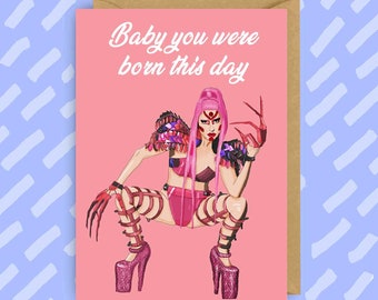 May include: Pink birthday card featuring a woman in a pink and black costume with long pink hair and red nails. The text on the card reads "Baby you were born this day."