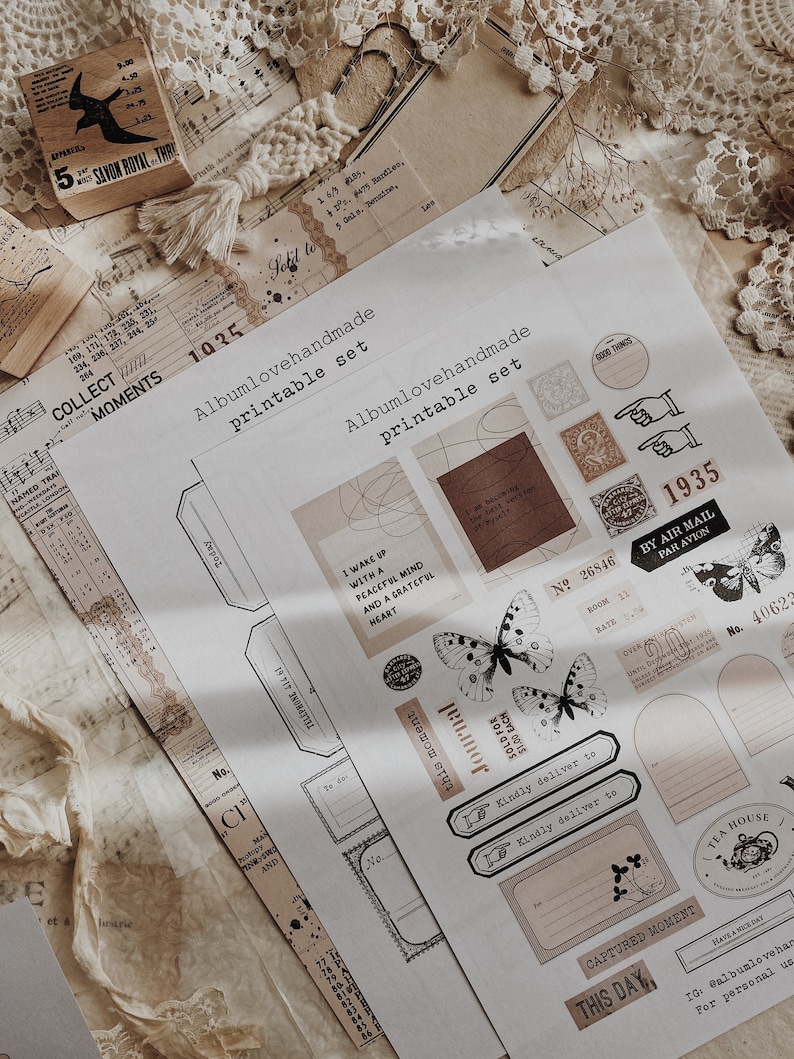 May include: A printable set of vintage-style stickers featuring butterflies, a journal, a stamp, and other decorative elements. The stickers are printed on white paper with a brown background.