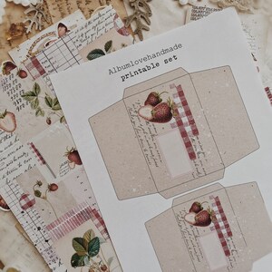May include: Printable set of two envelopes with a red and white gingham pattern and a strawberry illustration. The text "Albumlovehandmade Printable Set" is at the top of the page.