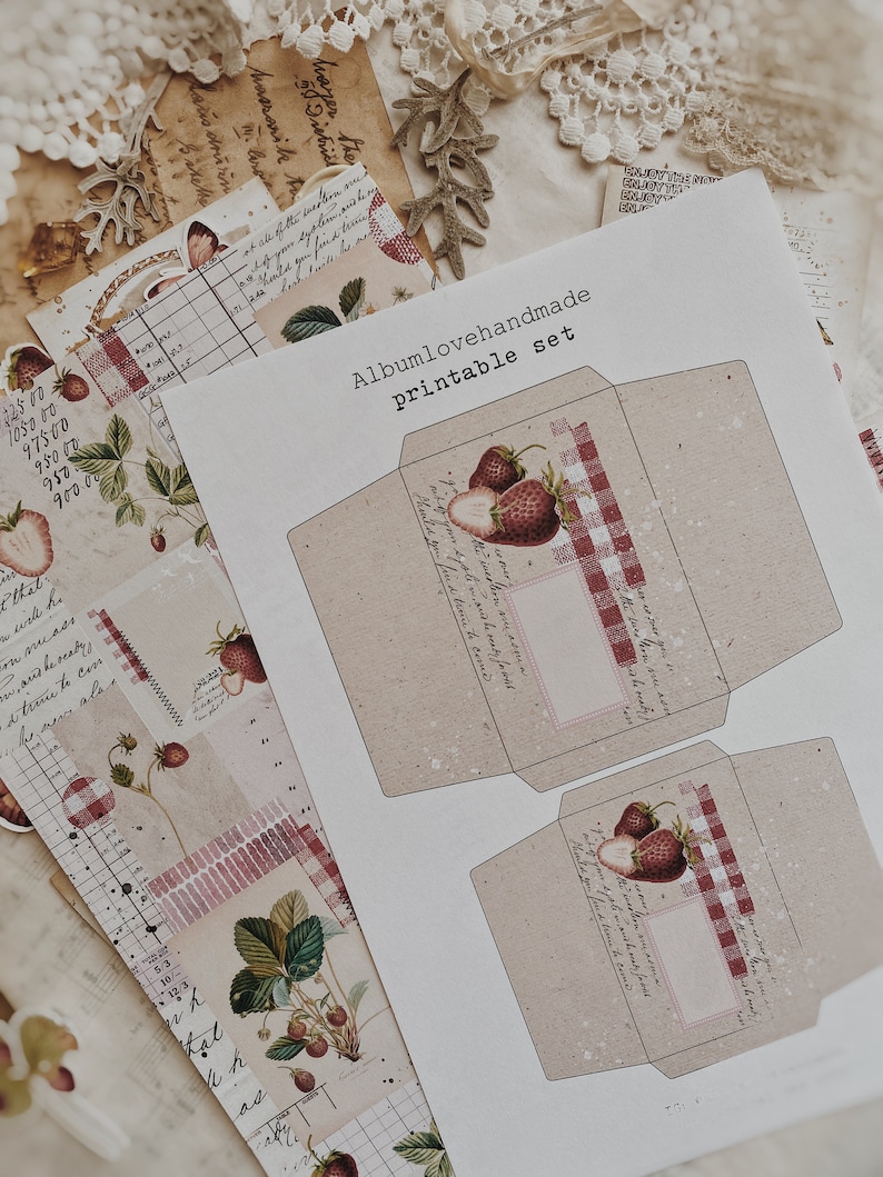 May include: Printable set of two envelopes with a red and white gingham pattern and a strawberry illustration. The text "Albumlovehandmade Printable Set" is at the top of the page.