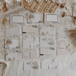 May include: A collection of vintage-style blank cards with a distressed, aged look. The cards feature various designs, including a map, a grid, and a stamp. The cards are perfect for journaling, scrapbooking, or adding a touch of vintage charm to your crafts.
