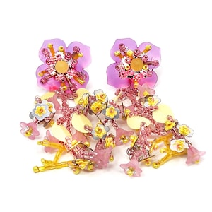 Statement hand beaded earring feature pink, silver and light-yellow flowers dangled on a brass bezel.