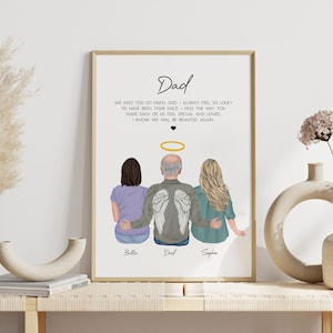 May include: A framed print featuring a hand-drawn illustration of three people standing back-to-back. The central figure is a man with angel wings and a halo. The text reads "Dad, We miss you so much Dad. I always feel so lucky to have been your child. I miss the way you made each of us feel special and loved. I know we will be reunited again." The names "Bella", "Dad", and "Sophia" are written beneath the figures.