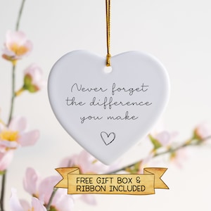 May include: White ceramic heart ornament with the text "Never forget the difference you make" and a small heart at the bottom. Free gift box and ribbon included.