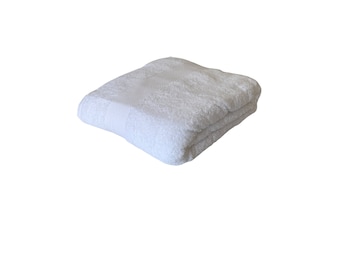May include: A white, folded, fluffy towel. The towel is made of soft, absorbent material.