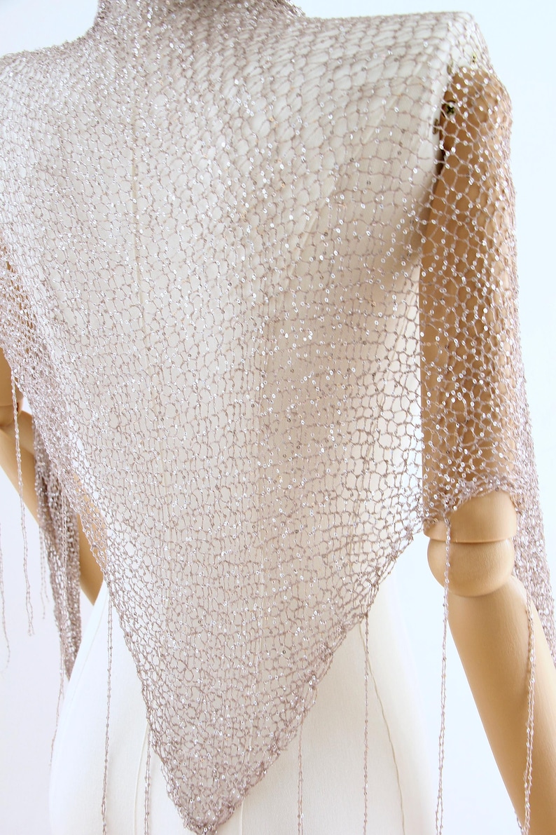 Hand knitted sparkly shawl for brides, featuring shimmering sequins and a delicate lightweight design.