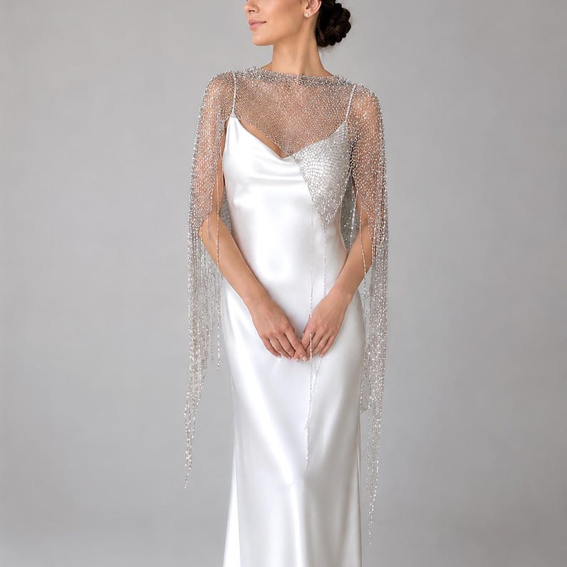 Silver sequin wrap worn over a wedding gown, creating a romantic and timeless bridal look.