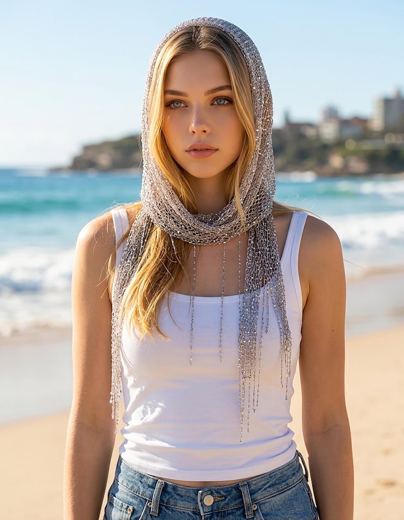 Silver sequin shawl worn as a headscarf, elegant beach accessory and lightweight scarf for summer vacations.