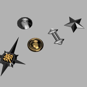 May include: Five different metal charms, including a star, a dome, a dumbbell, a round charm with a gold symbol, and a black star with a gold symbol.