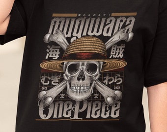 May include: Black t-shirt featuring a skull wearing a straw hat, crossed bones, and Japanese text. The shirt has the words "Mugiwara" and "One Piece" in a stylized font. The design is in shades of gray, brown, and white.