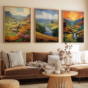 May include: A living room interior featuring a brown sectional sofa, three framed landscape paintings, and a wooden coffee table. The paintings depict scenic views of rolling hills, rivers, and valleys.