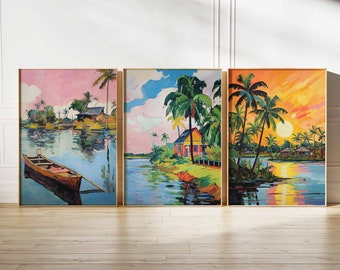 May include: Three framed paintings depicting tropical scenes. The first painting shows a pink sky with a small boat on a river, the second painting shows a blue sky with a house and palm trees, and the third painting shows a sunset with palm trees and a reflection of the sun in the water.
