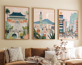 May include: Three framed art prints depicting cityscapes. The artwork features buildings, people, and greenery in a colorful, illustrative style. The frames are a light wood color, and the prints are displayed above a brown sofa with decorative pillows.