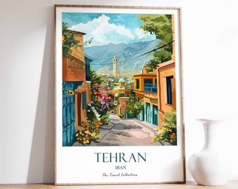 May include: A framed art print showing a street scene in Tehran, Iran. The artwork features a colourful alleyway with buildings in shades of orange and blue, with a mountain range in the background. The print includes the text "TEHRAN IRAN The Travel Collection."