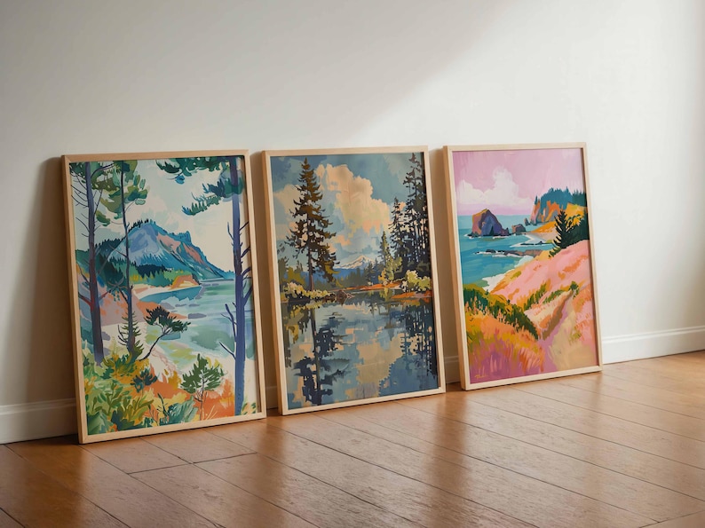 May include: Three framed landscape paintings with wooden frames. The paintings depict serene scenes of nature, including mountains, lakes, and coastal views. The color palettes feature blues, greens, pinks, and yellows, creating a calming and artistic aesthetic.