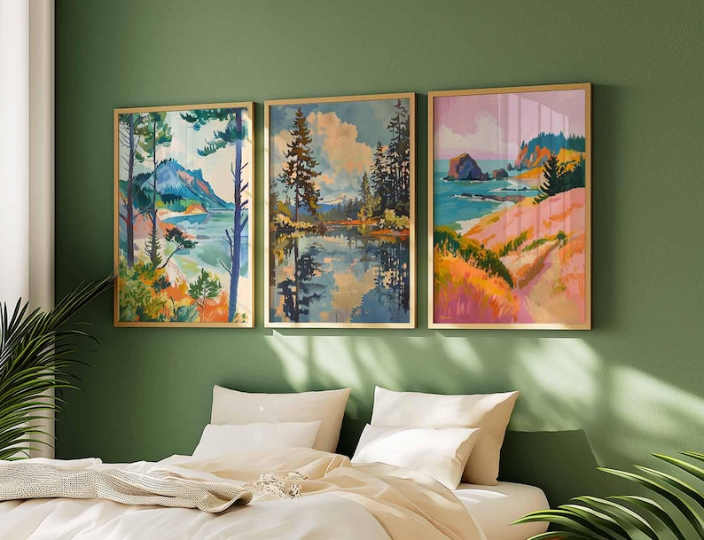 May include: Three framed landscape paintings with gold frames hang above a bed. The paintings depict colorful scenes of nature, including mountains, lakes, and coastal views. The artwork features a variety of colors, including blues, greens, pinks, and oranges.