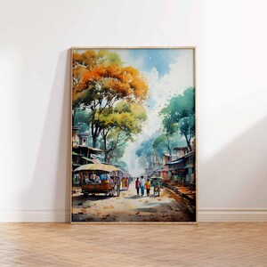May include: Watercolor painting of a street scene in a village. The street is lined with shops and trees. People are walking down the street. The painting is framed in a wooden frame.
