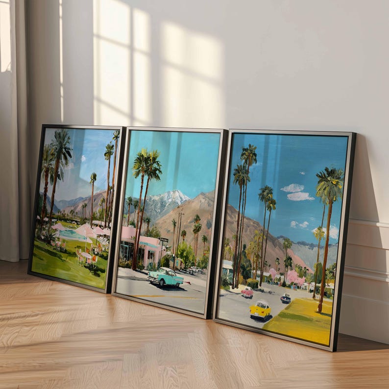 May include: Three framed landscape paintings depicting a sunny street scene with palm trees, mountains, and vintage cars. The artwork features a vibrant color palette of blue, pink, yellow, and green, with a mid-century modern aesthetic.