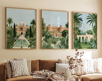 May include: Three framed wall art prints featuring watercolor-style illustrations of historical architecture, including a domed building with a reflecting pool, a large fortress, and an arched stone structure, all surrounded by lush green palm trees.