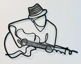 May include: A black and white line drawing of a person wearing a hat playing a guitar.