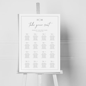 May include: A white wedding seating chart with the text "Take your seat" and the names "Harriet and Matthew" with the date "1st December 2023". The chart is divided into 16 sections, each labeled with a table number from 1 to 16. Each section lists the names of guests assigned to that table.