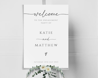 May include: White welcome sign with black text that reads "Welcome to the engagement party of Katie and Matthew, Saturday 12th July 2025".