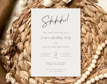 May include: A rectangular invitation card with the text "Shhh!" and details for a surprise birthday party for Katie and Matthew. The card is on a woven mat with decorative elements.