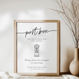 May include: A framed sign with the words "post box" in elegant script. Below, it reads "For your cards and well wishes." A line drawing of a post box is centered. The text "Thank you for your love and support on our special day" is below.