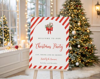 May include: A Christmas party welcome sign on an easel. The sign has a white background with red diagonal stripes and text that reads "Welcome to our Christmas Party". A Christmas tree is in the background.